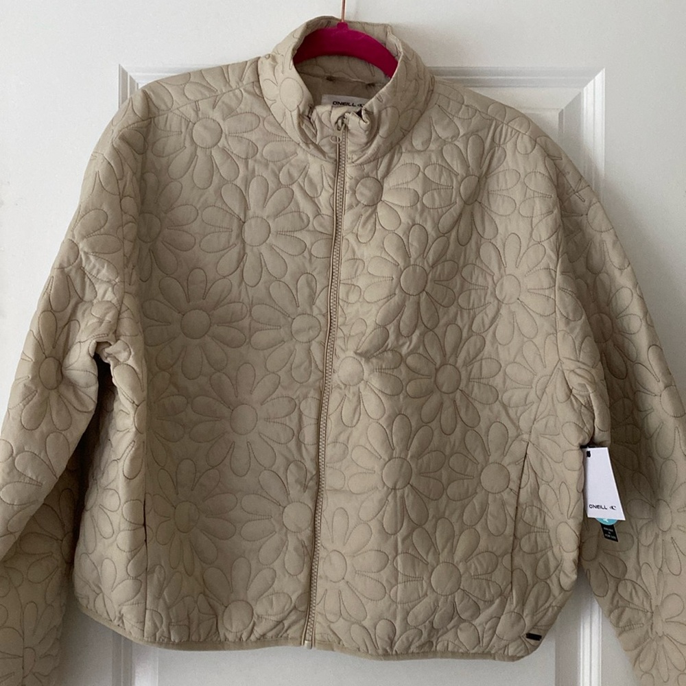 Adorable Beige O’Neilll jacket with flower imprint.